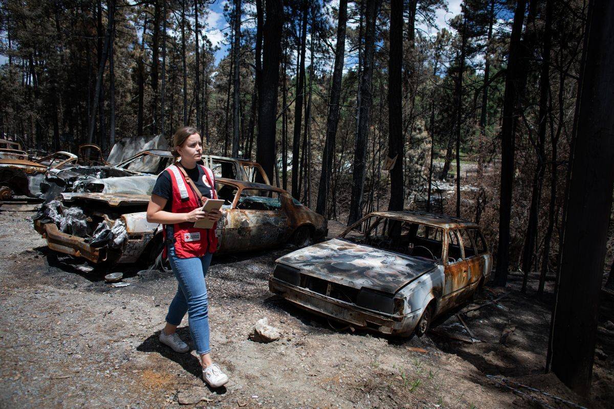 June 29, 2024. Ruidoso, New Mexico.
American Red Cross disaster worker Georgi Donchetz walks past cars abandoned during the evacuation. The South Fork and Salt Wildfires scorched more than 17,000 acres and destroyed entire neighborhoods.
Photo by Marko Kokic/American Red Cross