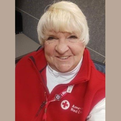Bobbie Krukowski smiling wearing Red Cross fleece jacket.