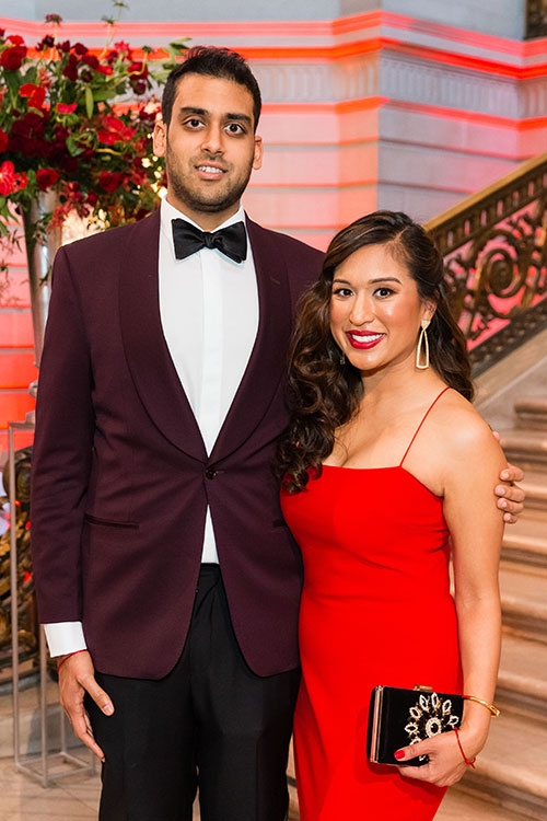 Nisha Baxi and another person at event in dress clothes.