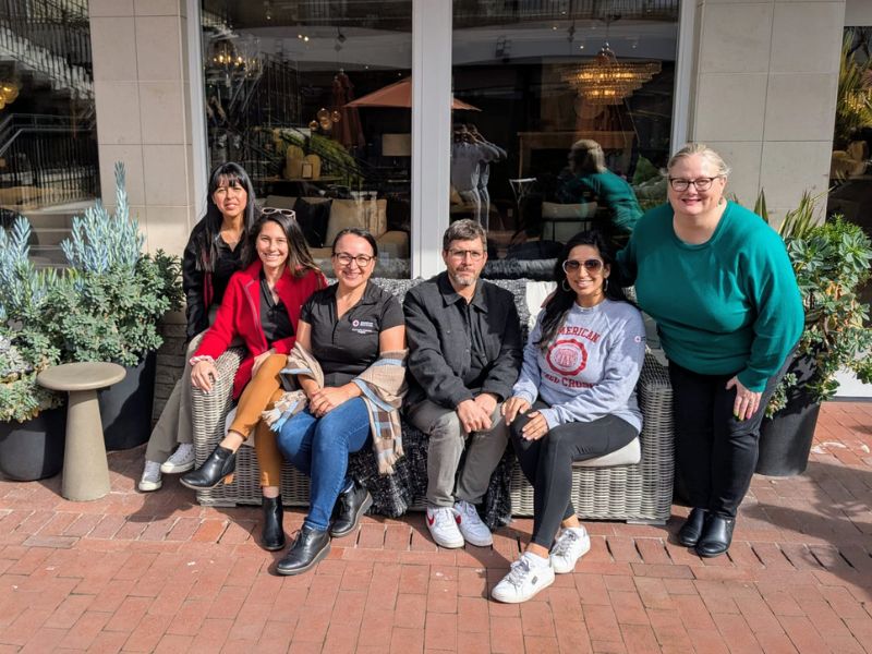 group of red crossers sitting on bench