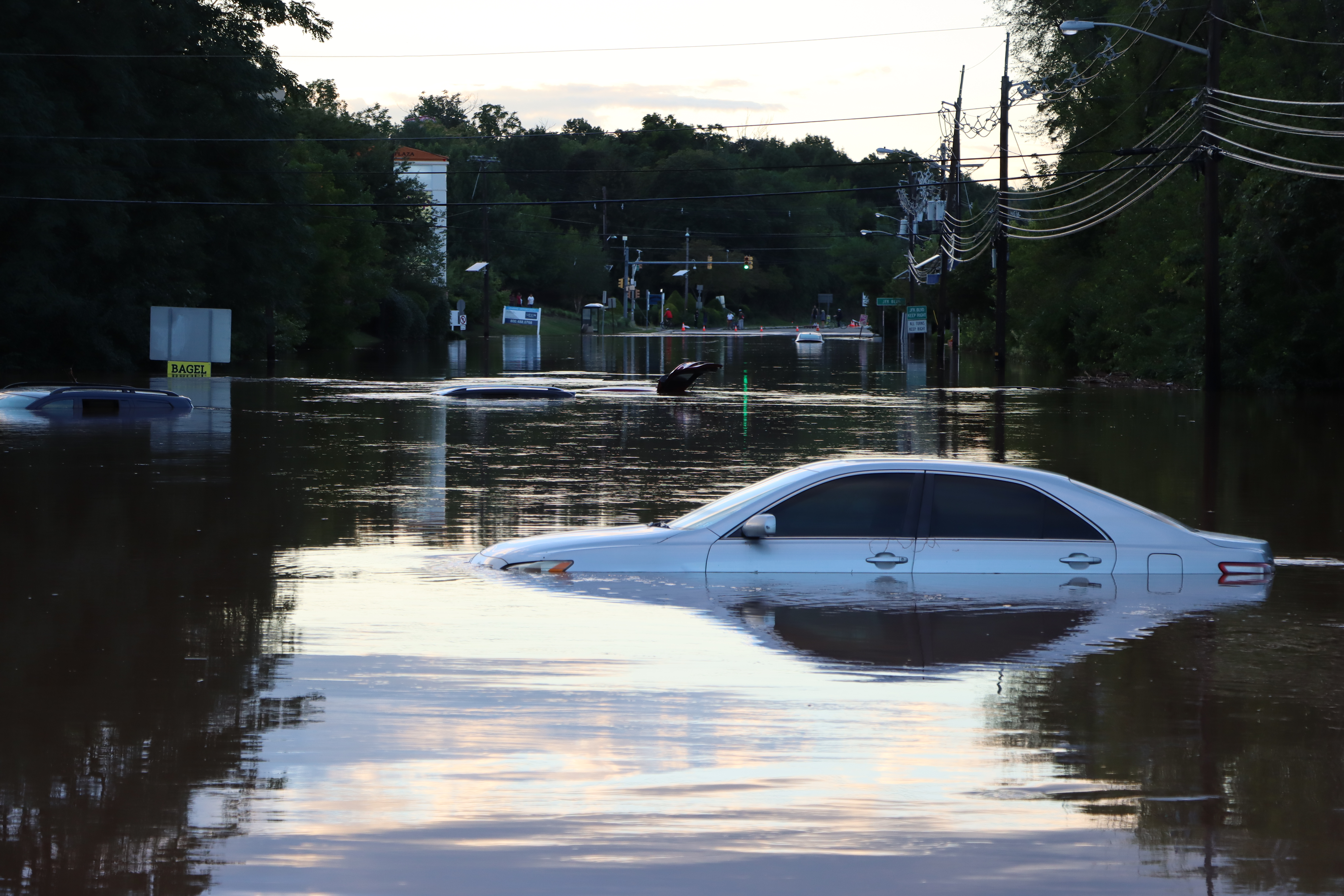 white car submerged in flood water